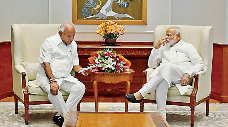 Chief Minister B.S. Yediyurappa apprising Prime Minister Narendra Modi of the damage caused by floods in the state, in New Delhi on Friday. (Photo: DC) Chief Minister B.S. Yediyurappa apprising Prime Minister Narendra Modi of the damage caused by floods in the state, in New Delhi on Friday. (Photo: DC)