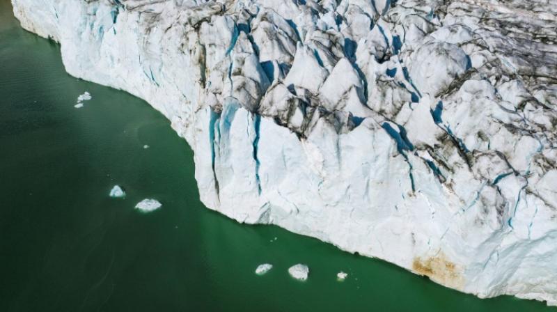 Skimming low over the gleaming white glaciers on Greenland's coast in a modified 1940s plane, three NASA scientists, led by an Elvis-impersonating oceanographer, waited to drop a probe into the water beneath them. (Photo: AFP) Skimming low over the gleaming white glaciers on Greenland's coast in a modified 1940s plane, three NASA scientists, led by an Elvis-impersonating oceanographer, waited to drop a probe into the water beneath them. (Photo: AFP)