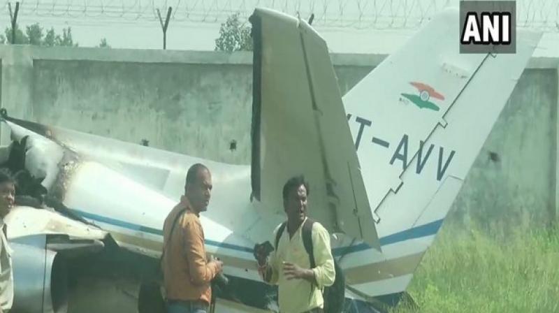 A trainer aircraft, VT-AVV, crashed here at the Dhanipur airstrip after one of its wheels got stuck in wires during the landing on Tuesday. (Photo: ANI) A trainer aircraft, VT-AVV, crashed here at the Dhanipur airstrip after one of its wheels got stuck in wires during the landing on Tuesday. (Photo: ANI)