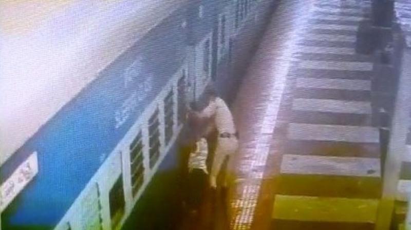 A Railway Protection Force (RPF) constable saved the life of a middle-aged passenger who lost the balance and had fallen between the gap of the platform and moving train while getting down. (Photo: ANI) A Railway Protection Force (RPF) constable saved the life of a middle-aged passenger who lost the balance and had fallen between the gap of the platform and moving train while getting down. (Photo: ANI)