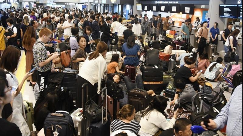 Around 17,000 passengers were stranded overnight at Tokyo's Narita Airport, an official said Tuesday, after it took a direct hit from a powerful typhoon that caused transport chaos throughout the capital. (Photo: AP) Around 17,000 passengers were stranded overnight at Tokyo's Narita Airport, an official said Tuesday, after it took a direct hit from a powerful typhoon that caused transport chaos throughout the capital. (Photo: AP)