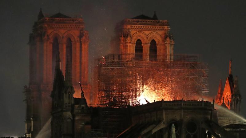 Firefighters tackle the blaze as flames and smoke rise from Notre Dame cathedral as it burns in Paris. (Photo: AP) Firefighters tackle the blaze as flames and smoke rise from Notre Dame cathedral as it burns in Paris. (Photo: AP)