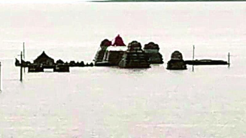 The temple’s gopuram gets submerged in floodwater at Kothapalli mandal in Kurnool district. (Photo: DC) The temple’s gopuram gets submerged in floodwater at Kothapalli mandal in Kurnool district. (Photo: DC)
