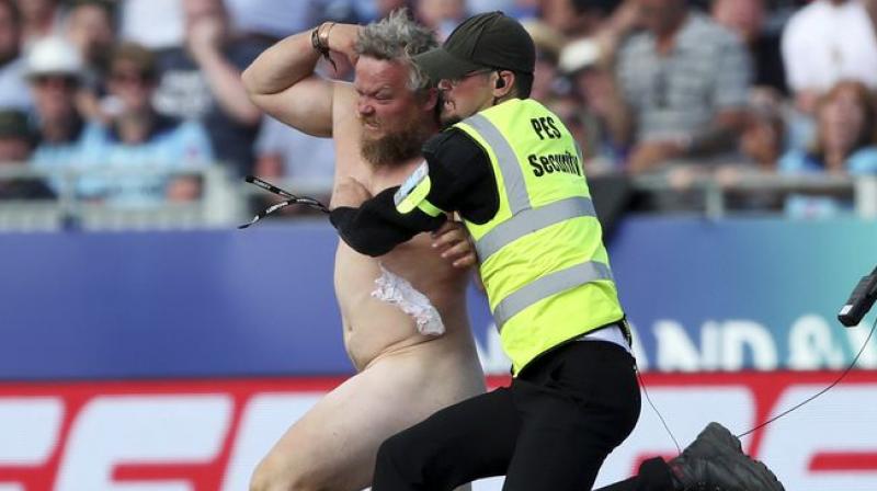 Stewards and security were extremely slow to react as the spectator halted play by jogging toward the middle of the field and dancing about in front of New Zealand batters Tom Latham and Mitchell Santner. (Photo:AP) Stewards and security were extremely slow to react as the spectator halted play by jogging toward the middle of the field and dancing about in front of New Zealand batters Tom Latham and Mitchell Santner. (Photo:AP)