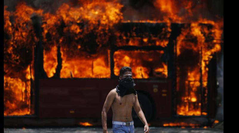Rioters later blocked the highway with a bus and set it on fire. (Photo: AP) Rioters later blocked the highway with a bus and set it on fire. (Photo: AP)