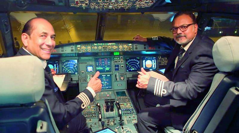 Pilot Chandra Rajesh, right, gets ready to fly the first direct flight to Singapore from Vijayawada airport. Pilot Chandra Rajesh, right, gets ready to fly the first direct flight to Singapore from Vijayawada airport.