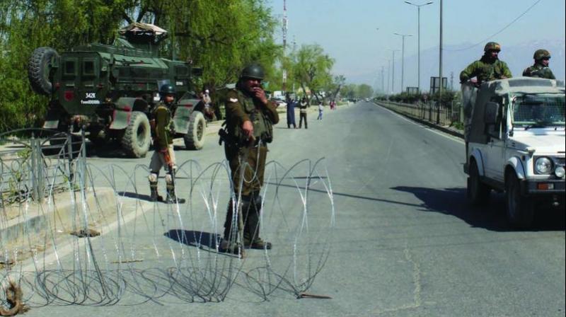 Security personnel stand guard on the Jammu-Srinagar-Baramulla national highway on the outskirts of Srinagar on Sunday. (Photo: H.U. Naqash) Security personnel stand guard on the Jammu-Srinagar-Baramulla national highway on the outskirts of Srinagar on Sunday. (Photo: H.U. Naqash)