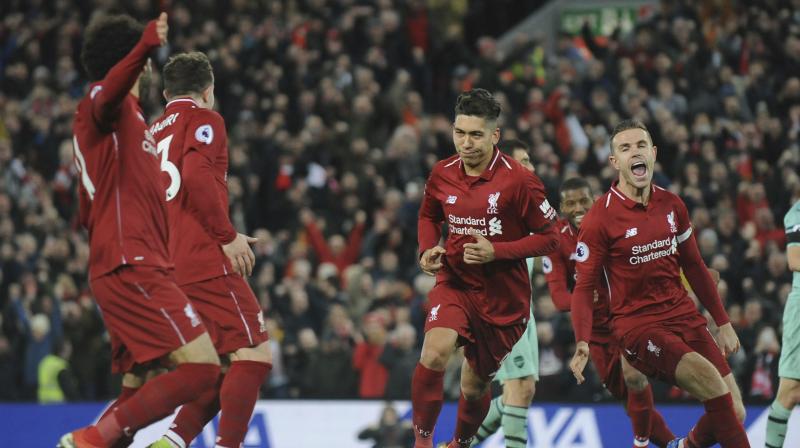 Liverpool extended their Premier League lead to nine points as Roberto Firmino's hat-trick hammered Arsenal 5-1 at Anfield, while Tottenham's title challenge crumbled in a 3-1 home defeat to Wolves. (Photo: AP) Liverpool extended their Premier League lead to nine points as Roberto Firmino's hat-trick hammered Arsenal 5-1 at Anfield, while Tottenham's title challenge crumbled in a 3-1 home defeat to Wolves. (Photo: AP)