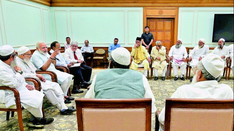 A delegation of leaders from the Muslim community under the umbrella of the Jamiat Ulama-i-Hind meet Prime Minister Narendra Modi in New Delhi on Tuesday. (Photo: PTI) A delegation of leaders from the Muslim community under the umbrella of the Jamiat Ulama-i-Hind meet Prime Minister Narendra Modi in New Delhi on Tuesday. (Photo: PTI)