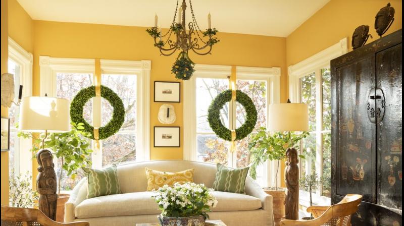 This photo shows a room design by Josh Hildreth. This Washington, D.C., sunroom feels bright even on winter afternoons, thanks to windows that don't have any draperies, a light-colored rug and citrus trees that add a fresh, bright scent to the space.AP This photo shows a room design by Josh Hildreth. This Washington, D.C., sunroom feels bright even on winter afternoons, thanks to windows that don't have any draperies, a light-colored rug and citrus trees that add a fresh, bright scent to the space.AP