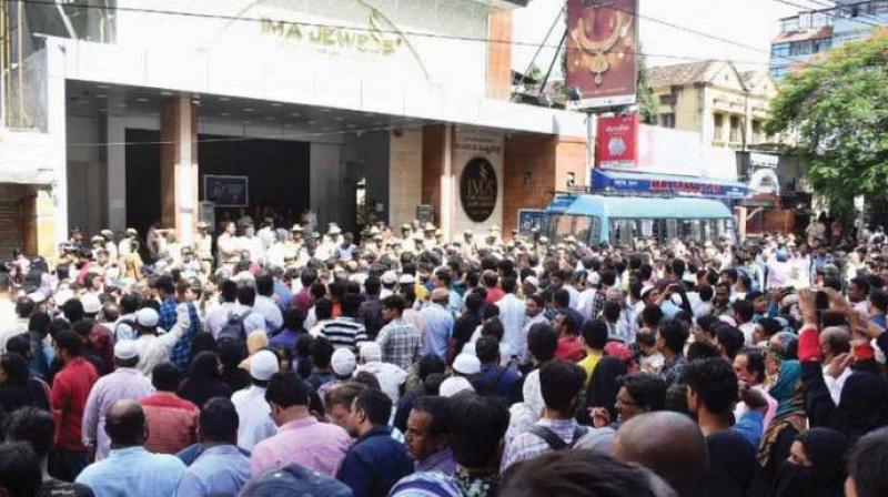 File picture of police and investors outside IMA Jewels. File picture of police and investors outside IMA Jewels.