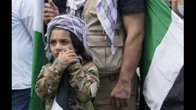 Far from being settled, Afghanistan is perilously poised. Yasif Nazari, 6, leans on a flag pole as he wears an Afghanistan military uniform as he listens to speakers at a rally to support the Afghan government Representational Image. (AP)