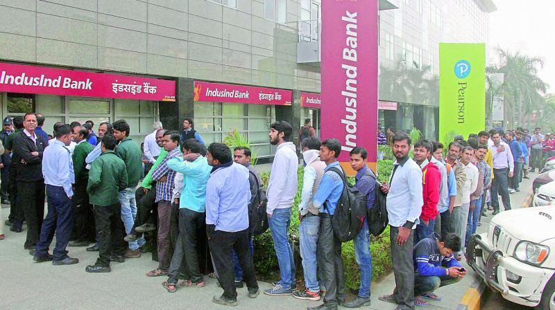 People queue up outside a bank to withdraw cash. (Photo: PTI) People queue up outside a bank to withdraw cash. (Photo: PTI)