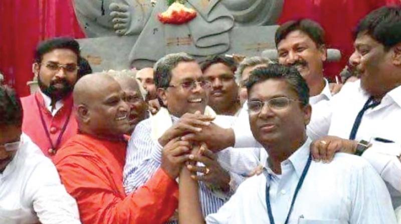 A file photo of Congress’ Satish Jarkiholi with senior party leaders Siddaramaiah and H.C. Mahadevappa A file photo of Congress’ Satish Jarkiholi with senior party leaders Siddaramaiah and H.C. Mahadevappa