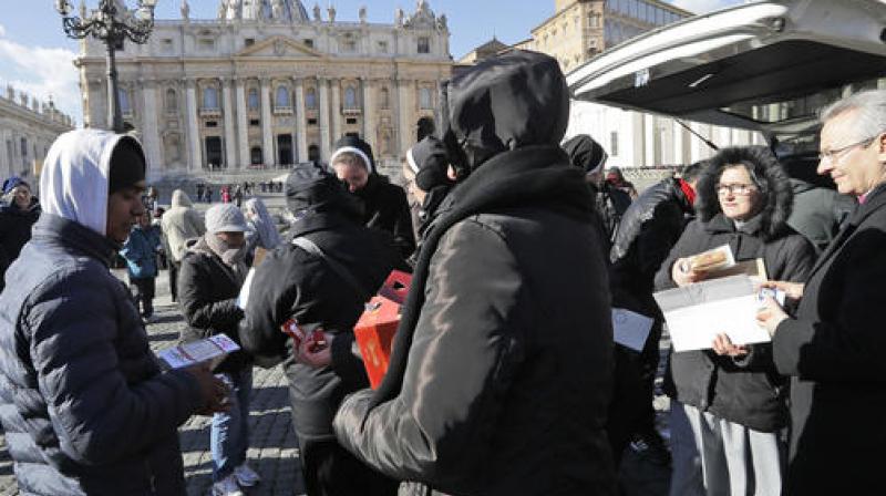 Nuns distribute food and drinks to needy people in St. Peter's square at the Vatican. (Photo: AP) Nuns distribute food and drinks to needy people in St. Peter's square at the Vatican. (Photo: AP)
