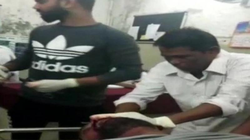 The sweeper (right, in white shirt) in question was involved in a similar incident three months ago when he was filmed giving stitches to another patient. (Photo: ANI) The sweeper (right, in white shirt) in question was involved in a similar incident three months ago when he was filmed giving stitches to another patient. (Photo: ANI)