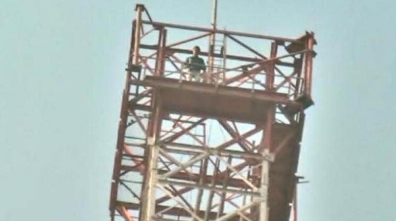 Upendra Singh Rathore climbed the 350-feet tall tower, saying he will descend only when the movie is banned across the country. (Photo: ANI) Upendra Singh Rathore climbed the 350-feet tall tower, saying he will descend only when the movie is banned across the country. (Photo: ANI)