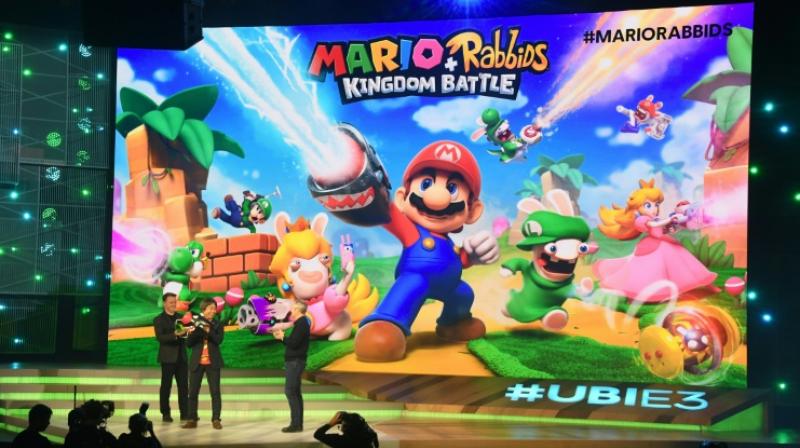 Ubisoft CEO Yves Guillemot (R) and game designer and producer Shigeru Miyamoto (C) introduce Ubisoft CEO Yves Guillemot (R) and game designer and producer Shigeru Miyamoto (C) introduce