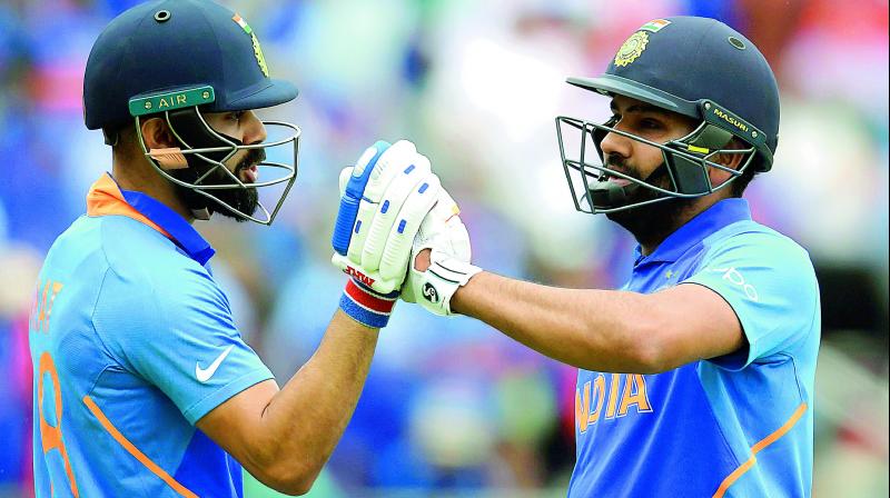 Virat Kohli (left) congratulates Rohit Sharma during the match against Bangladesh. Virat Kohli (left) congratulates Rohit Sharma during the match against Bangladesh.