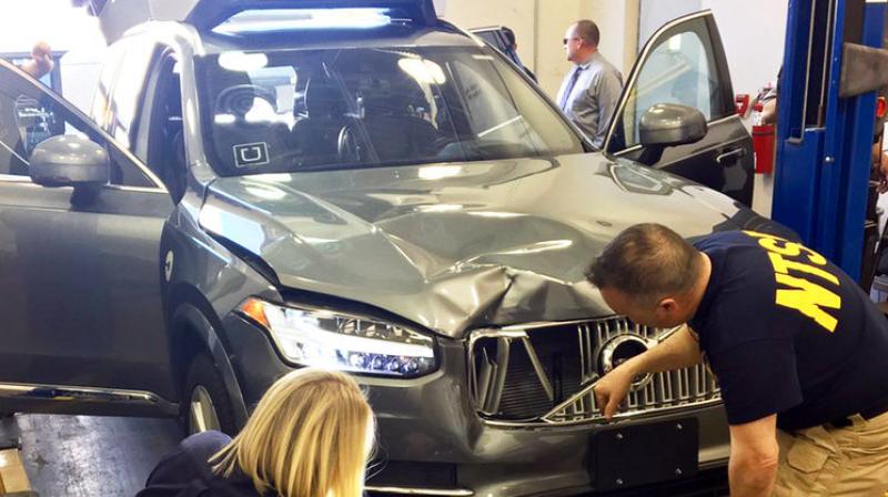 Photo provided by the National Transportation Safety Board, investigators examine a driverless Uber SUV that fatally struck a woman in Tempe, Ariz.(Photo: AP) Photo provided by the National Transportation Safety Board, investigators examine a driverless Uber SUV that fatally struck a woman in Tempe, Ariz.(Photo: AP)