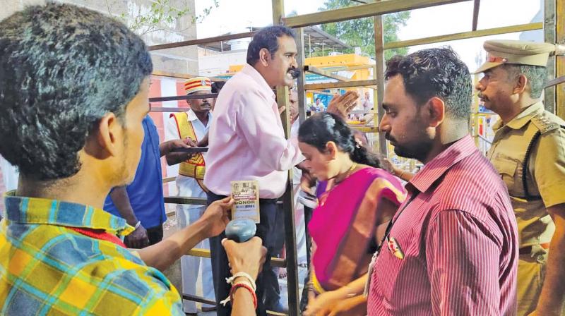 Kanchi Collector P. Ponnaiah personally checking the pass-holders at the temple entry on Tuesday. (DC) Kanchi Collector P. Ponnaiah personally checking the pass-holders at the temple entry on Tuesday. (DC)