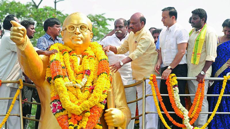 Minister for Roads and Buildings Ch. Ayyanna Patrudu pay floral tributes to the statue of social reformer Dr B.R. Ambedkar during the 126th birth anniversary celebrations at Dabagardens in Visakhapatnam on Friday. (Photo: DECCAN CHRONICLE) Minister for Roads and Buildings Ch. Ayyanna Patrudu pay floral tributes to the statue of social reformer Dr B.R. Ambedkar during the 126th birth anniversary celebrations at Dabagardens in Visakhapatnam on Friday. (Photo: DECCAN CHRONICLE)