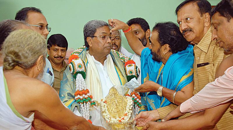 CM Siddaramaiah being greeted by Hindu priests at his home office, Krishna in Bengaluru on Wednesday CM Siddaramaiah being greeted by Hindu priests at his home office, Krishna in Bengaluru on Wednesday