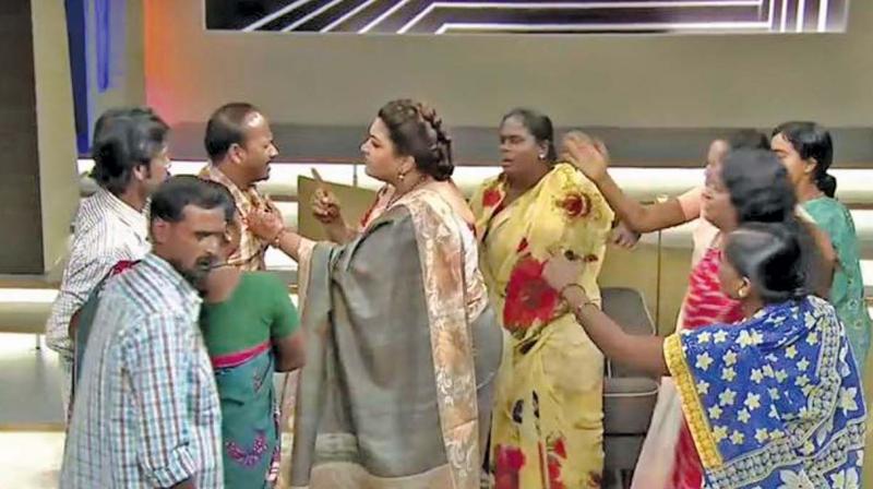Khushbu holding the collar of a participant on the sets of Nijangal Khushbu holding the collar of a participant on the sets of Nijangal