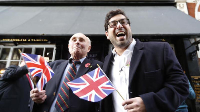 UK Independence Party (UKIP) leadership hopeful Raheem Kassam, right, poses for a photograph with former Royal Marine Dave Smith, 73, in Westminster, London. (Photo: AP) UK Independence Party (UKIP) leadership hopeful Raheem Kassam, right, poses for a photograph with former Royal Marine Dave Smith, 73, in Westminster, London. (Photo: AP)