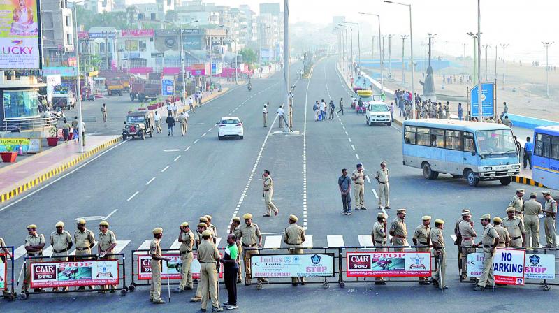 Police personnel barricade a road to prevent people from going to R.K. Beach to take part in a silent protest seeking the special category status for Andhra Pradesh. (Photo: DC) Police personnel barricade a road to prevent people from going to R.K. Beach to take part in a silent protest seeking the special category status for Andhra Pradesh. (Photo: DC)