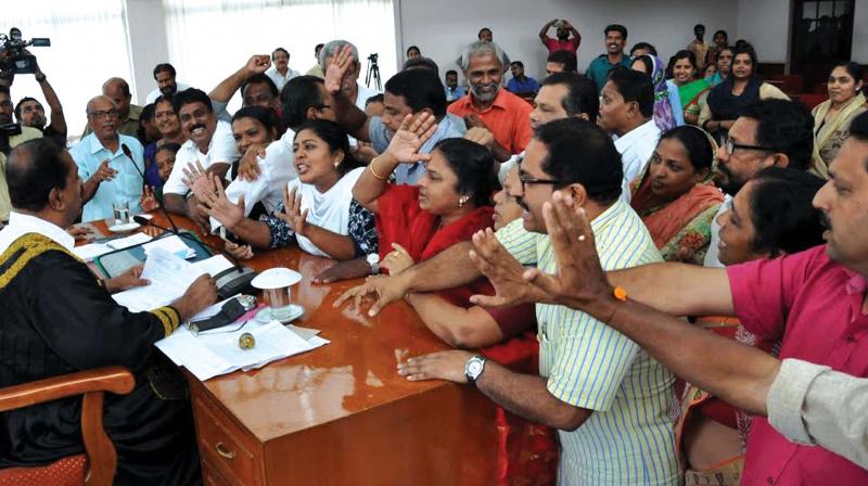 Opposition members in Kozhikode Corporation gheraoing Mayor Thottathil Raveendran over Street light contract issue on Tuesday. (Photo: Viswajith K) Opposition members in Kozhikode Corporation gheraoing Mayor Thottathil Raveendran over Street light contract issue on Tuesday. (Photo: Viswajith K)