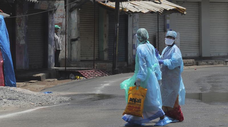 Health workers collect details as they survey a neighborhood amid concerns over the spread of new coronavirus in New Delhi, India. AP Photo