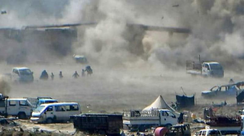 People flee as heavy smoke rises above the ISIS group's last remaining position in Syria. (Photo: AFP) People flee as heavy smoke rises above the ISIS group's last remaining position in Syria. (Photo: AFP)