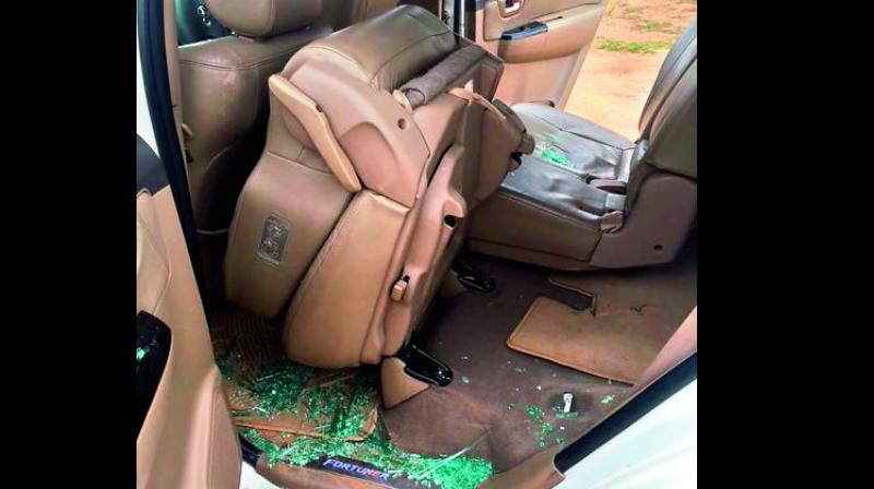 In this picture released by the AICC, broken glass piece are seen inside a car after alleged stone pelting at Congress vice-president Rahul Gandhi’s convoy during his visit to flood affected Dhanera village of Banaskantha district on Friday. (Photo: PTI) In this picture released by the AICC, broken glass piece are seen inside a car after alleged stone pelting at Congress vice-president Rahul Gandhi’s convoy during his visit to flood affected Dhanera village of Banaskantha district on Friday. (Photo: PTI)