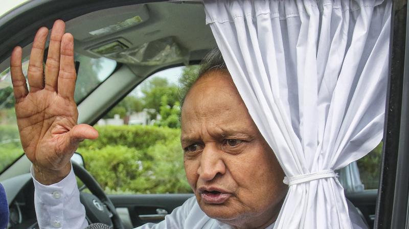 Rajasthan Chief Minister Ashok Gehlot speaks to the media persons as he leaves the airport after arriving back from Jaisalmer to Jaipur, Saturday. (PTI)