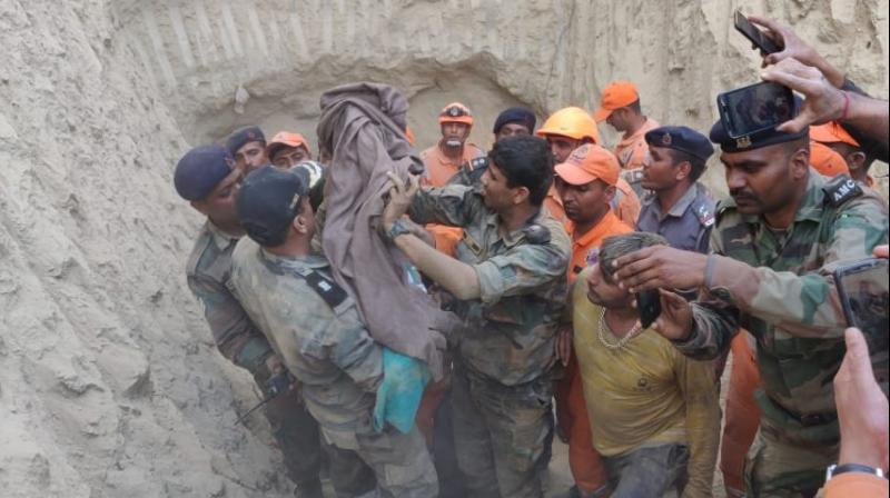 As the rescuers on Friday reached close to the spot where the child was trapped, digging by machines was stopped and was carried out manually to ensure that soil did not fall over the infant, officials said. (Image: ANI) As the rescuers on Friday reached close to the spot where the child was trapped, digging by machines was stopped and was carried out manually to ensure that soil did not fall over the infant, officials said. (Image: ANI)