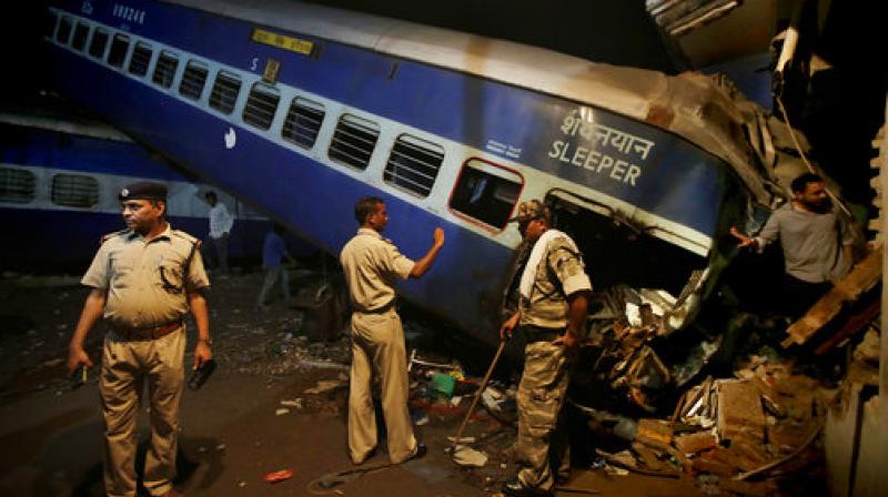 Policemen stand guard near the upturned coaches of the Kalinga-Utkal Express after an accident near Khatauli in Uttar Pradesh. (Photo: PTI) Policemen stand guard near the upturned coaches of the Kalinga-Utkal Express after an accident near Khatauli in Uttar Pradesh. (Photo: PTI)