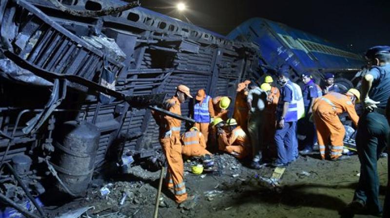 The NDRF rescue team at the mangled coaches of the Puri-Haridwar Utkal Express train after it derailed in Khatauli near Muzaffarnagar on Saturday. (Photo: PTI) The NDRF rescue team at the mangled coaches of the Puri-Haridwar Utkal Express train after it derailed in Khatauli near Muzaffarnagar on Saturday. (Photo: PTI)
