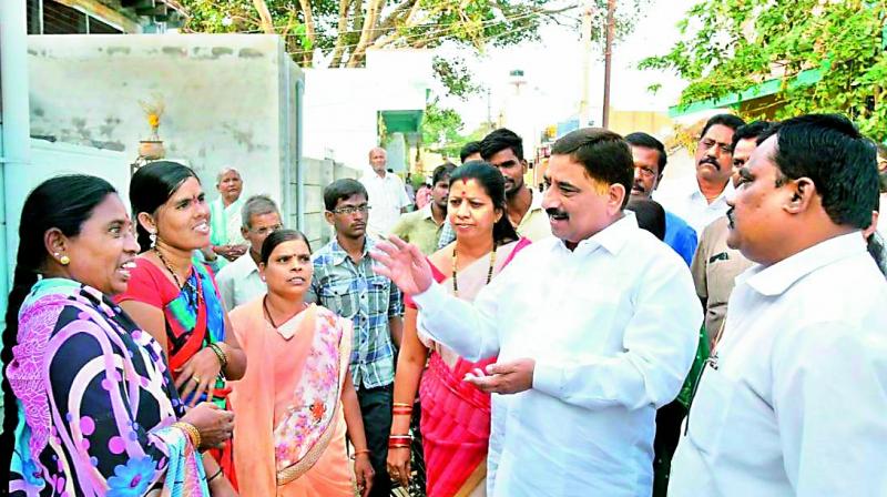 Minister Kalava Srinivas speaks to parents in Gummagatta about joining their daughters back to schools (Photo: DC) Minister Kalava Srinivas speaks to parents in Gummagatta about joining their daughters back to schools (Photo: DC)