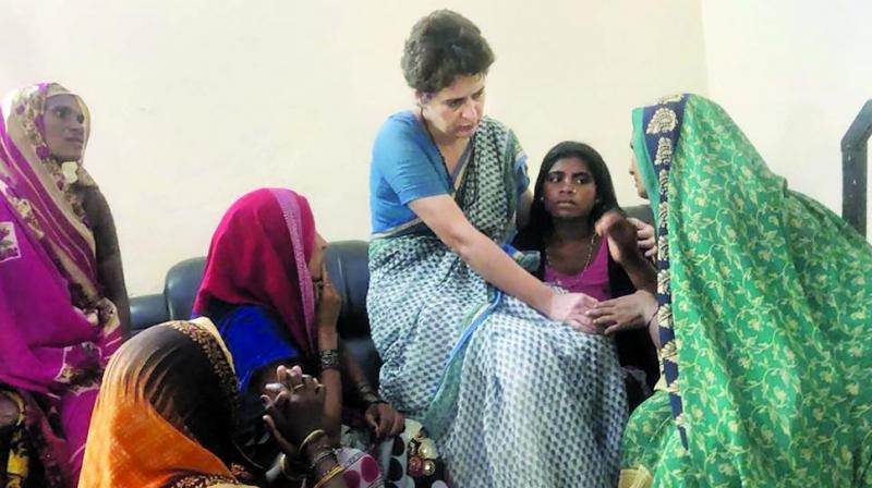 Priyanka Gandhi Vadra with family members of Sonbhadra massacre victims in Mirzapur. (Photo: PTI) Priyanka Gandhi Vadra with family members of Sonbhadra massacre victims in Mirzapur. (Photo: PTI)