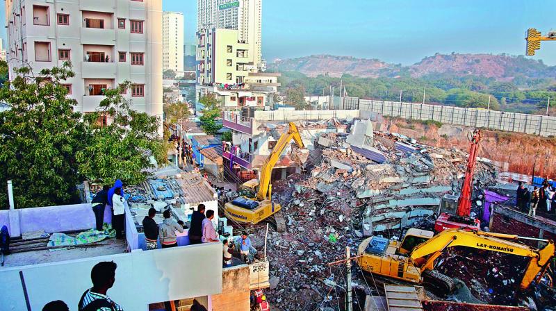 Salvage teams work on Friday to remove the debris of the under-construction building that came down in layers at Nanakaramguda on Thursday. (Photo: AFP) Salvage teams work on Friday to remove the debris of the under-construction building that came down in layers at Nanakaramguda on Thursday. (Photo: AFP)