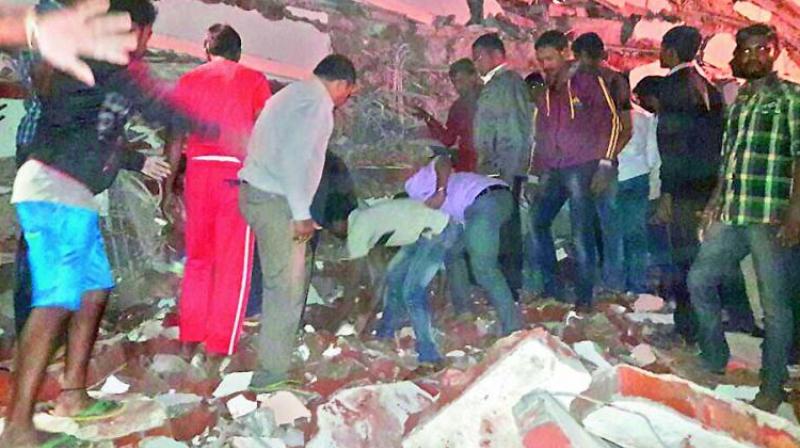 Locals and rescue workers search for bodies feared buried under the debris of a collapsed five-storey building at Nanakramguda on Thursday. (Photo: DC) Locals and rescue workers search for bodies feared buried under the debris of a collapsed five-storey building at Nanakramguda on Thursday. (Photo: DC)