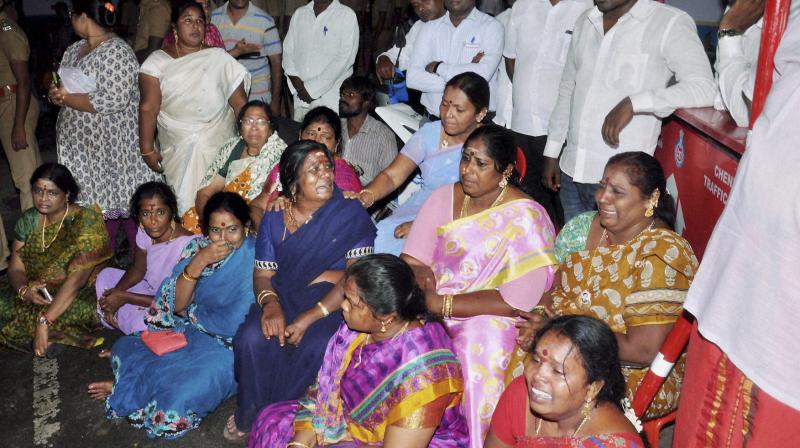 AIADMK supporters sit in front of Apollo Hospital after Tamil Nadu Chief Minister, Jayalalithaa suffered a cardiac arrest in Chennai. (Photo: PTI) AIADMK supporters sit in front of Apollo Hospital after Tamil Nadu Chief Minister, Jayalalithaa suffered a cardiac arrest in Chennai. (Photo: PTI)