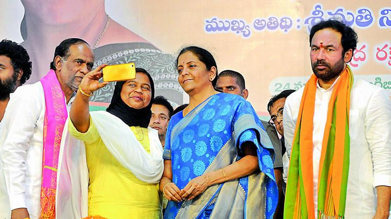 Defence minister Nirmala Sitharaman obliges a party worker with a selfie as BJP state president Dr K. Laxman looks on, at a public meeting at Exhibition Grounds on Sunday. (Photo: Deepak Deshpande) Defence minister Nirmala Sitharaman obliges a party worker with a selfie as BJP state president Dr K. Laxman looks on, at a public meeting at Exhibition Grounds on Sunday. (Photo: Deepak Deshpande)