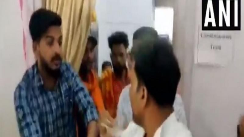 Visuals show the BJP workers raising slogans and slapping the NCP worker, following which he was taken away by the police from the SDM office. (Photo: ANI) Visuals show the BJP workers raising slogans and slapping the NCP worker, following which he was taken away by the police from the SDM office. (Photo: ANI)