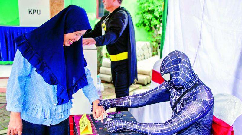 Indonesian election workers dressed in superhero costumes register voters at a polling station in Surabaya on Wednesday. Indonesia kicked off one of the world’s biggest one-day elections, pitting president Joko Widodo against ex-general Prabowo Subianto in a race to lead the Muslim-majority nation. (Photo: AFP) Indonesian election workers dressed in superhero costumes register voters at a polling station in Surabaya on Wednesday. Indonesia kicked off one of the world’s biggest one-day elections, pitting president Joko Widodo against ex-general Prabowo Subianto in a race to lead the Muslim-majority nation. (Photo: AFP)