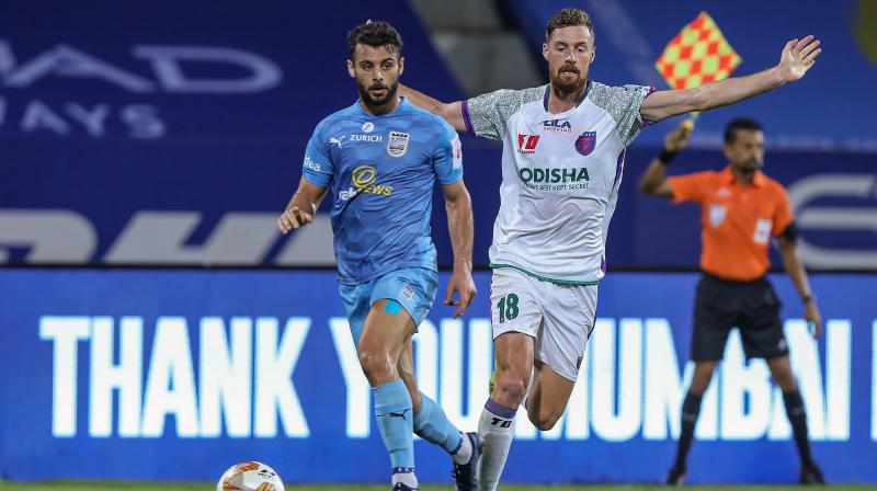 Hugo Boumous of Mumbai City FC and Jacob Tratt of Odisha FC in action during their Indian Super League match at the GMC Stadium Bambolim, Goa, Sunday, Dec. 6, 2020. (PTI