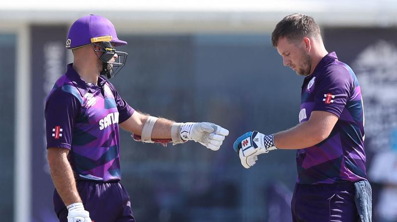 Scotlands batsman George Munsey, left, with captain Kyle Coetzer run between wickets during the Cricket Twenty20 World Cup first round match between Oman and Scotland in Muscat, Oman, on Thursday. (Photo: AP)