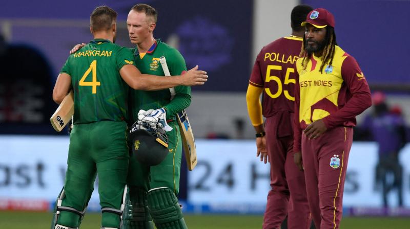 South Africas Aiden Markram (L) and Rassie van der Dussen celebrate their victory next to West Indies Chris Gayle (R) at the end of the during the ICC mens Twenty20 World Cup cricket match between South Africa and West Indies at the Dubai International Cricket Stadium in Dubai on Tuesday. (Photo: AFP)