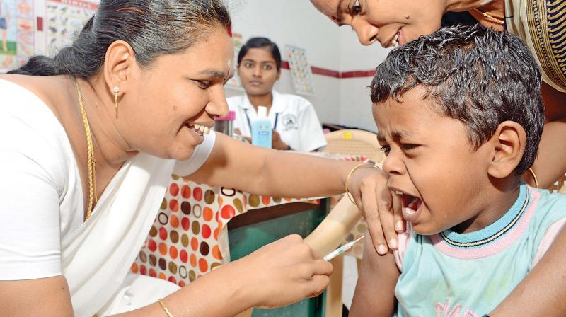 A child gets Measles Rubella vaccination at Ashok Nagar. A child gets Measles Rubella vaccination at Ashok Nagar.